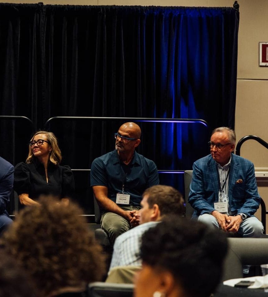 APBFRM faculty panel seated on stage at a regenerative medicine summit
